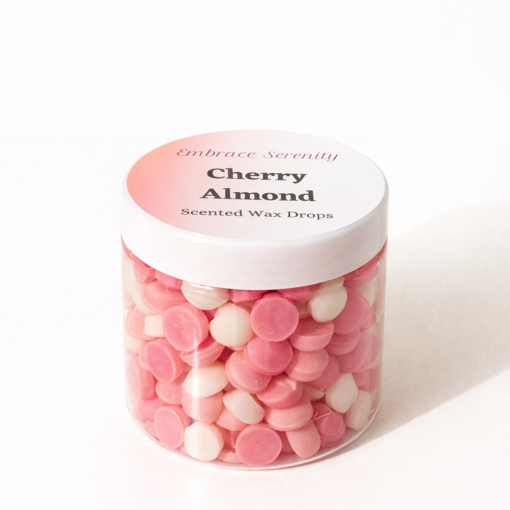 Jar of Cherry Almond scented wax drops with a white lid on a white background
