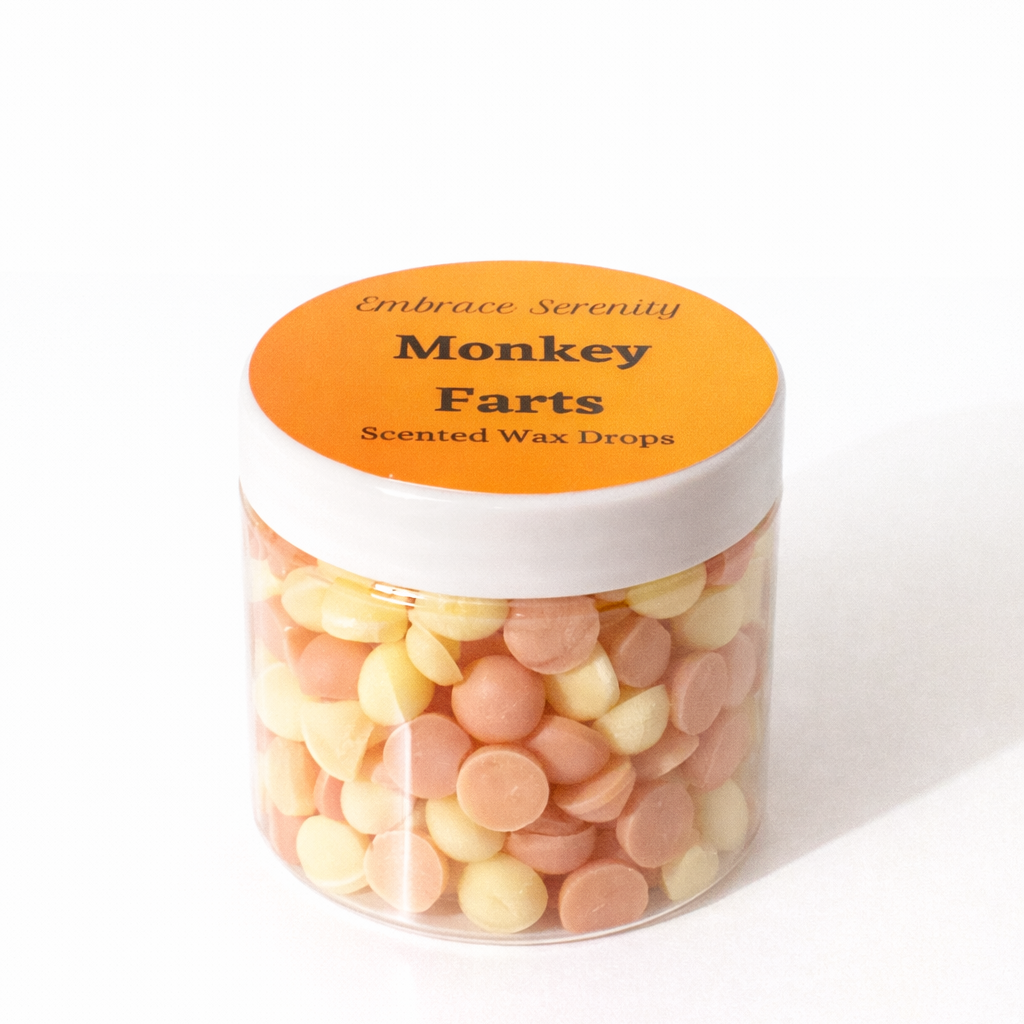 Jar of 'Monkey Farts' scented wax drops with an orange label on a white background